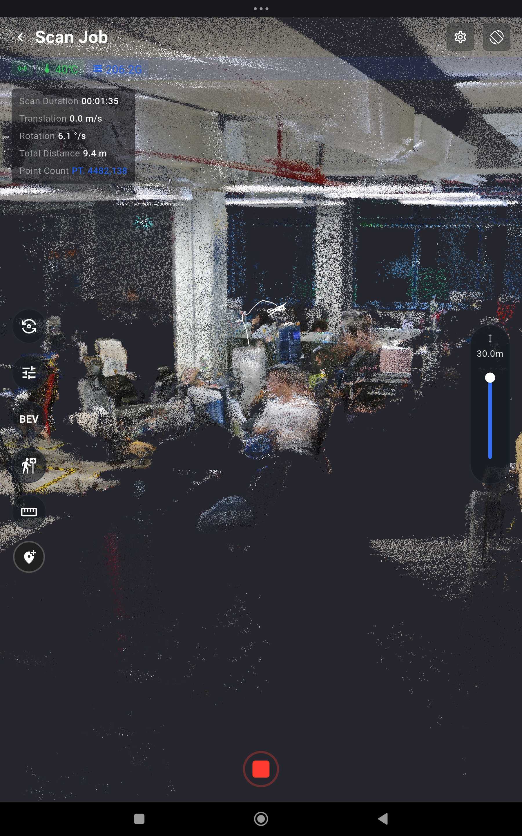 The MindCloud Go Scan Job view part-way through an office capture, showing a colourised point cloud of desks, structural columns and ceiling services, with telemetry reading Scan Duration one minute 35 seconds, Rotation 6.1 degrees per second, Total Distance 9.4 metres and Point Count 4,482,138, and a red stop button at the bottom